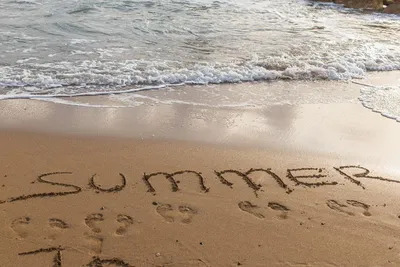 Premium Photo | Summer 2023 lettering on the sandy beach and sea water