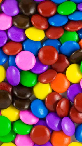 Конфеты Обои на телефон куча разноцветных круглых конфет