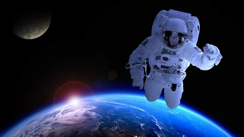Космоса Фото человек в скафандре, плавающий в космосе
