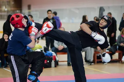 Muscular kick-box or muay thai fighter punching in smoke. Stock Photo by  ©zamuruev 123030098