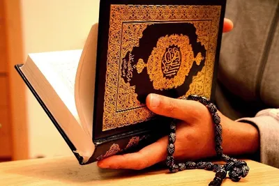 Premium Photo | Holy islamic book koran on the draped table with a rosary.  ramadan kareem beautiful poster, banner,