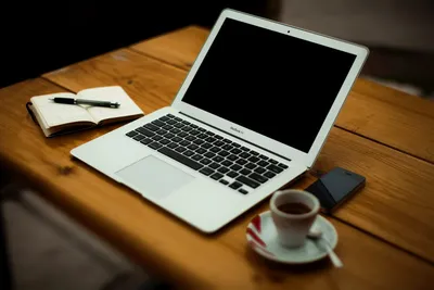 Laptop and cup of coffee on old wooden table Stock Photo by ©Kitzcorner  77270446