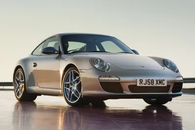 Premium Photo | A red porsche 911 is driving down a street