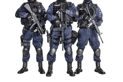Spec ops police officer SWAT in black uniform and face mask, studio shot  Stock Photo - Alamy