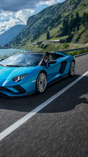 Lamborghini Обои на телефон человек за рулем синего спортивного автомобиля по дороге с горами на заднем плане