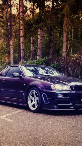 Nissan Skyline R34 Обои на телефон черный автомобиль, припаркованный в лесистой местности