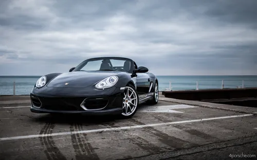 Porsche Обои на телефон черный автомобиль, припаркованный на бетонной поверхности у воды