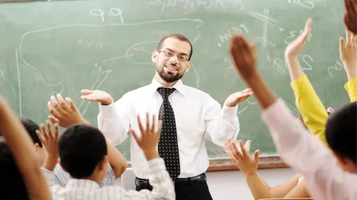 С Днем Учителя 2021 Картинки человек в галстуке и очках, стоящий перед классной комнатой