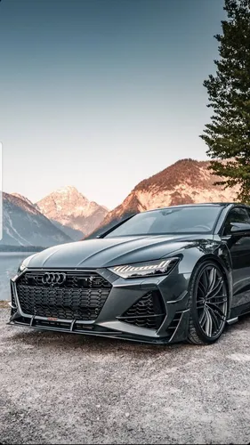 Audi Rs7 Обои на телефон черный автомобиль, припаркованный на дороге с горами на заднем плане