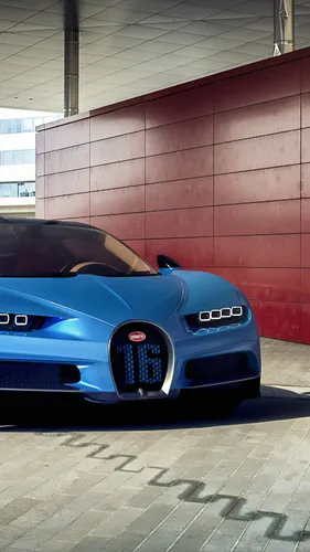 Bugatti Chiron Обои на телефон синий автомобиль, припаркованный перед кирпичным зданием