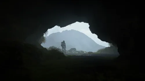 Death Stranding Обои на телефон человек, стоящий в темной пещере