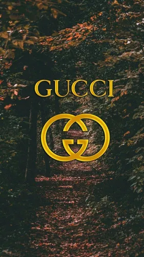 Gucci Обои на телефон желтый логотип на коричневой поверхности