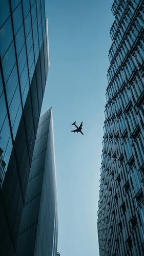 Здания Обои на телефон самолет, летящий между двумя небоскребами