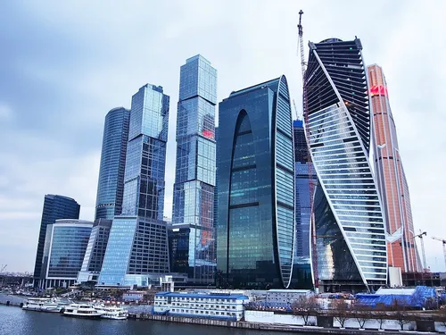 Москва Сити Фото группа высоких зданий рядом с водоемом с центром Ренессанс на заднем плане