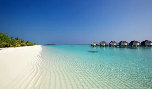 Мальдивы Обои на телефон пляж с хижинами на нем
